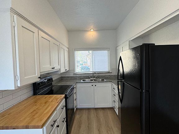 Kitchen with oven, dishwasher, and refrigerator.