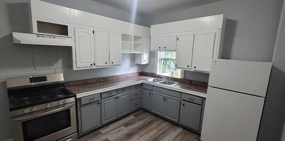 Clean, open and spacious kitchen with back door that leads to a cover back porch