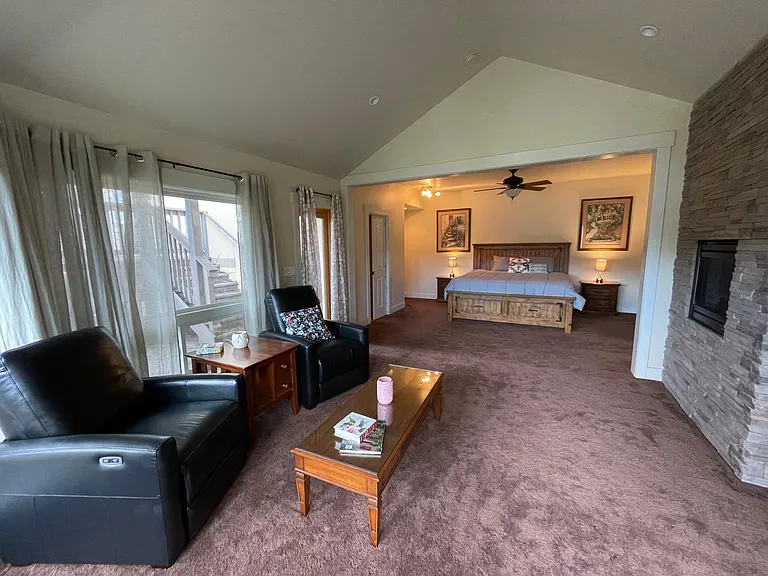 Master Suite on the lower floor with gas fireplace, flat screen TV and private seating area. Opens to a attached Patio.