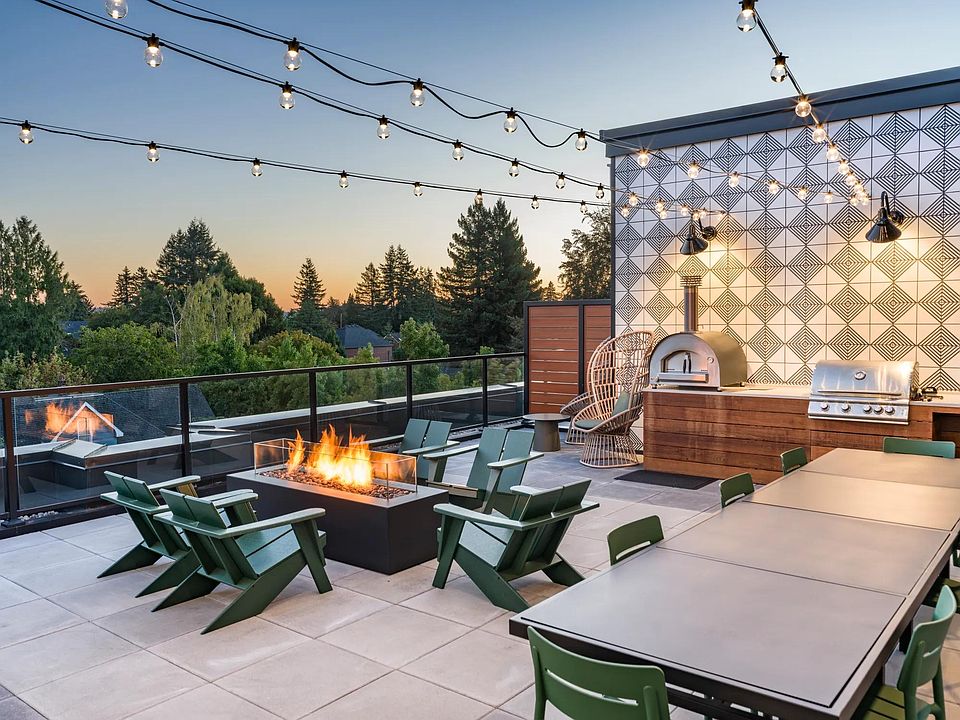 Ascend to the 5th floor retreat featuring a TV lounge, fireplace, full kitchen, and an outdoor terrace equipped with a grilling station and pizza oven.