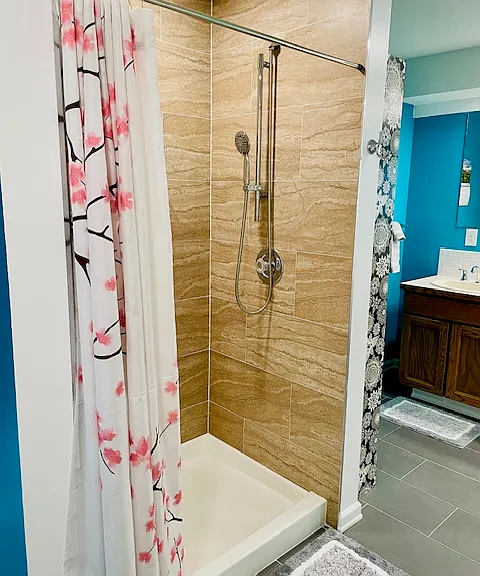 Shower in master bathroom has an adjustable and detachable showerhead.