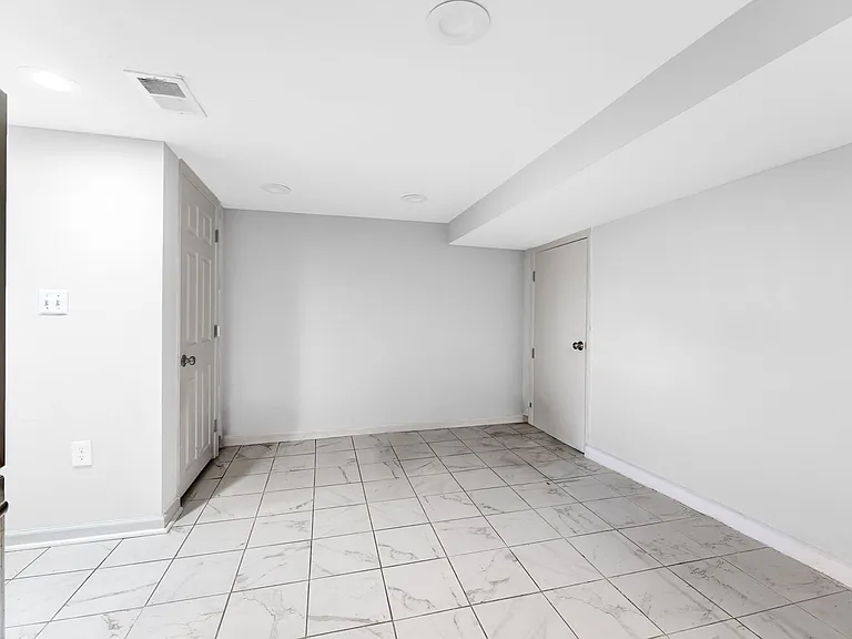 Additional storage closets to left of refrigerator and plenty of room for dining table and chairs.