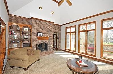 This impressive great room is bright and airy.  A full wall of brick houses the fireplace and book-shelves.  Dramatic deep trey ceiling is just part of the charm of this truly great room.