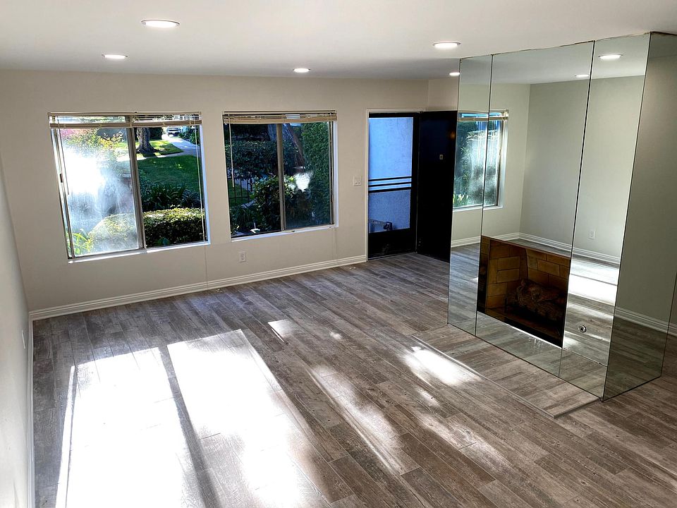 Main entry and living room. Lots of natural lights coming from two oversize windows.