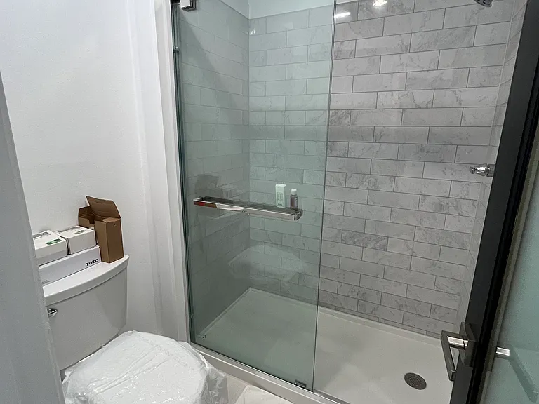 Master shower, new walk in shower, and toilet.