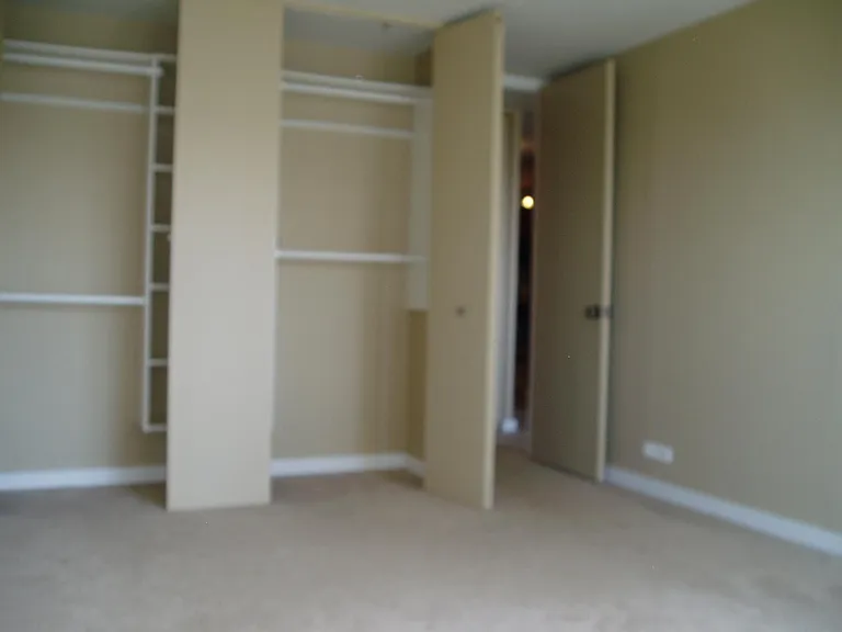 OLD PHOTO. Bedroom Closet Has Been Painted White with New Heavy Duty Shelving system installed.