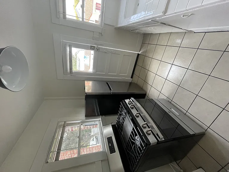 Kitchen with gas range and lots of windows at The Villas Apartments in Pasadena, CA.