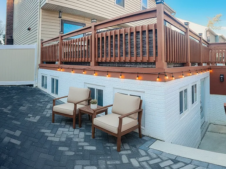 Exterior stairway and private entrance area leading down to the apartment.