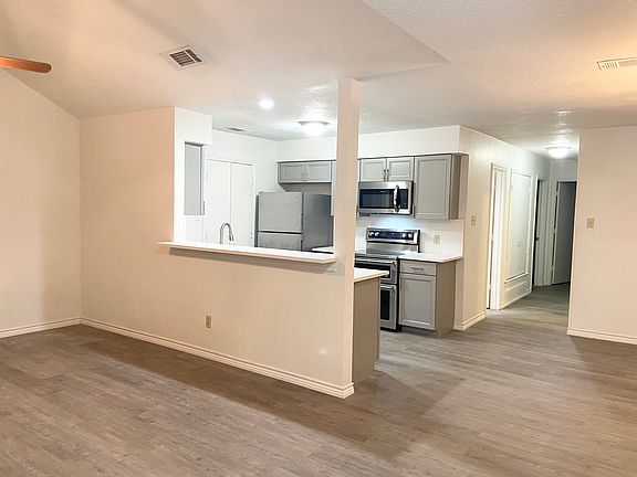View of kitchen from the living room with wood floors throughout