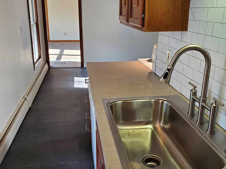 Entry view of kitchen with new deep sink and bridge faucet