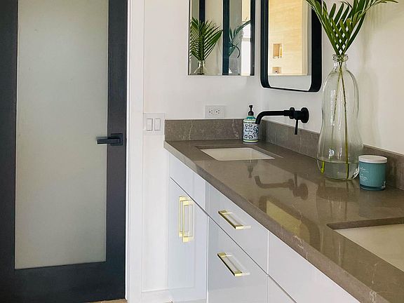Elegant two sink vanity with separate toilet room.