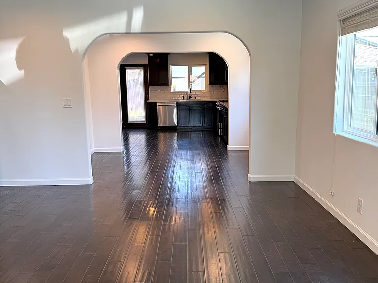 Bright living room filled with natural light and dimmable recessed LED lighting.