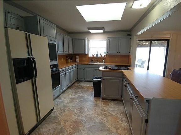 Plenty of counter space and room to work in kitchen with large skylight and window above sink.