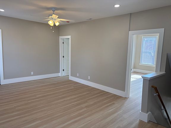 Living room at the top of the stairs with lots of natural light.