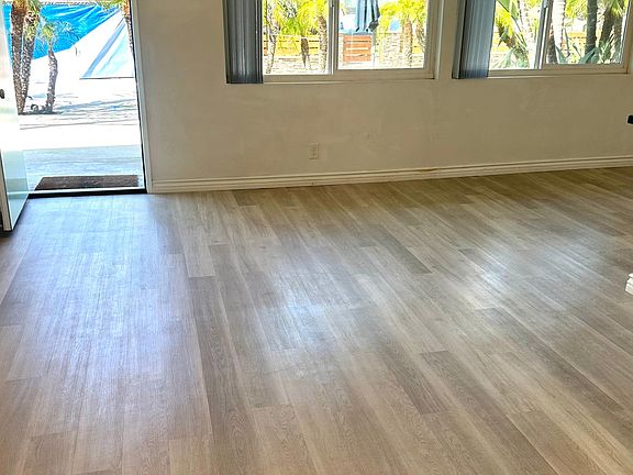 Spacious living room with huge windows overlooking your patio and greenery outside