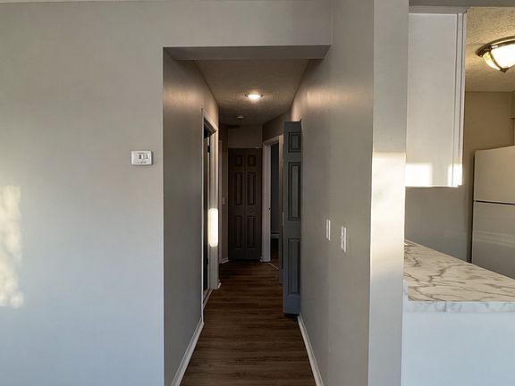 The hallway offers two separate storage closets, including a linen closet and a generously sized storage closet, providing ample space for organization.