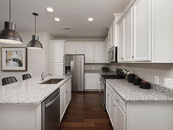 Model Representation - Stunning Kitchen with White Cabinetry and Stainless Steel Appliances