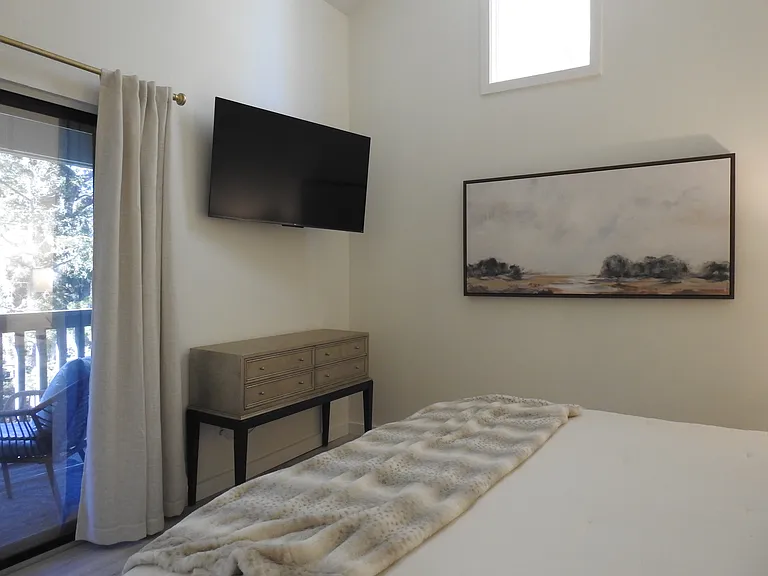 Wall mounted TV in primary bedroom