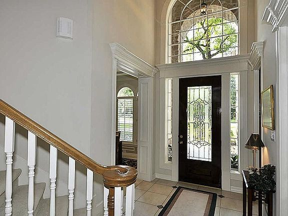 Home feels roomy the moment you enter! Extraordinary 20 foot foyer, etched glass, bright transoms & walnut door. Marvelous neutral travertine floor & custom chandelier. Crown molding in all formal rooms, game & bedrooms (most double dental crown)!