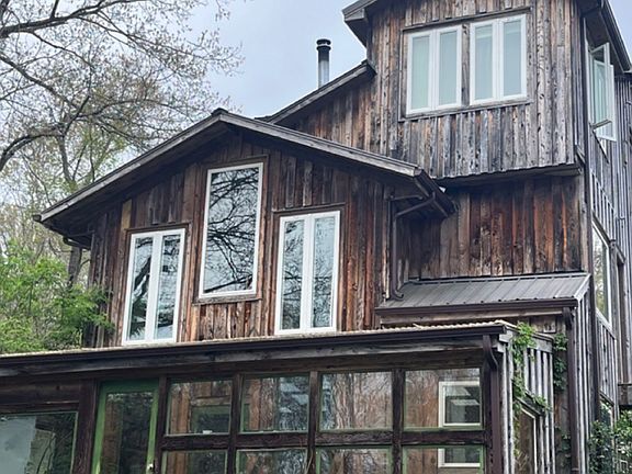 Back of the house, showing the office/bedroom (top right), living room (three windows - middle left), and attached greenhouse.
