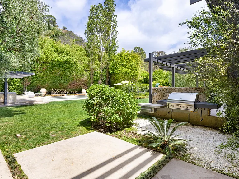 Take a dip in the gorgeous pool, conveniently located next to the outdoor BBQ and seating area.