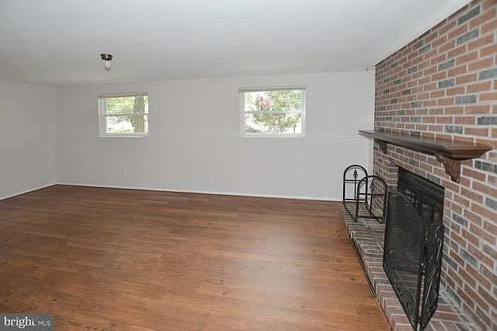 Side view of downstairs living room/ family room & fireplace.