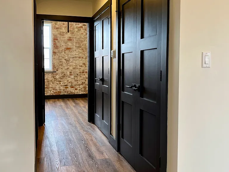 Hallway features gorgeous shaker doors to protect utility closet.
