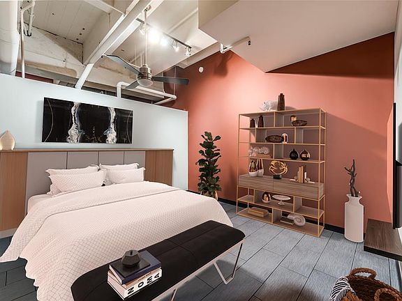 The Primary Bedroom is spacious at approx. 16x14 (Buyer to verify dimensions). Modern tile floors are easy to maintain! Exposed ductwork, plumbing and cement ceiling add to the lofty feel. AMAZING walk-in closet with custom Elfa organization system t