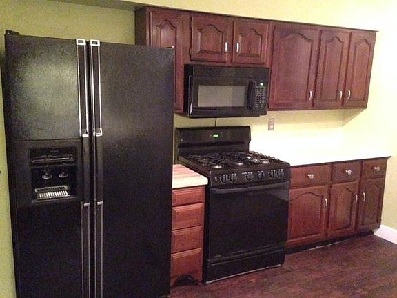 Half of Kitchen. Six burner range, microwave, stove. That small cabinet with butcher block top rolls out for easier use.