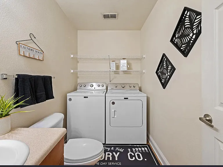 Down stairs bathroom with washer and dryer