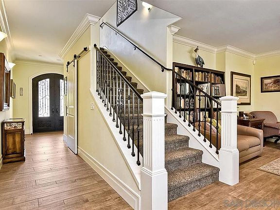 Large entry way, high ceilings and crown moulding throughout provide an open and airy room for family gatherings, game nights or entertaining friends.