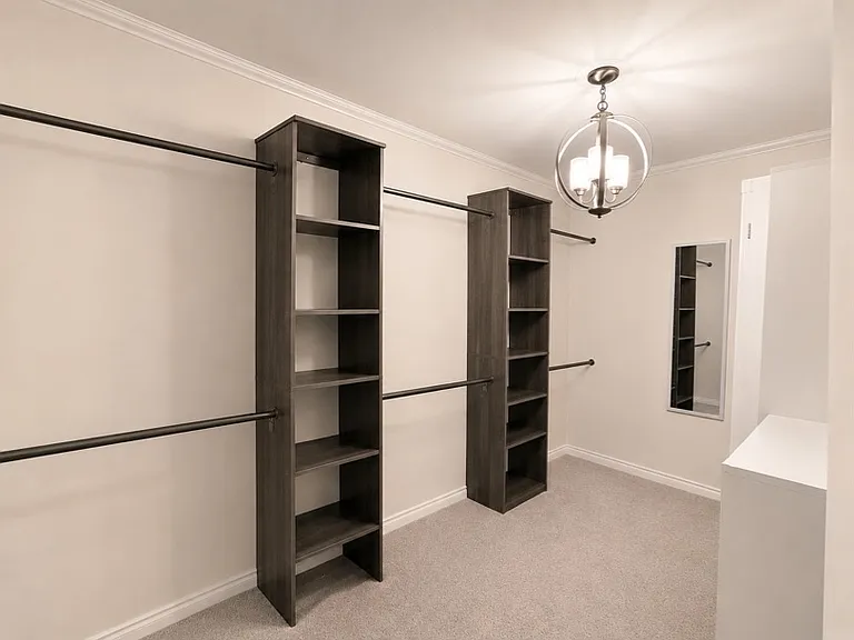 Primary walk-in closet with built in closet system.