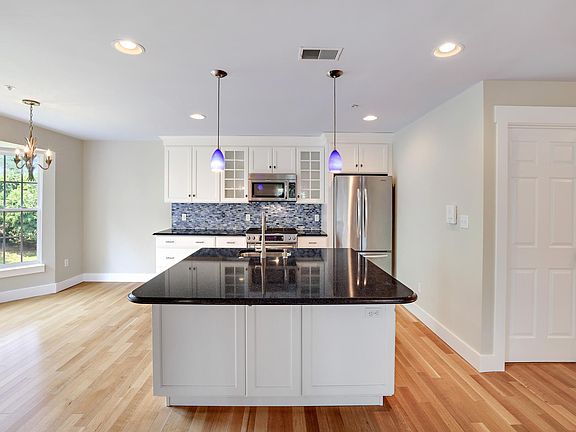 Large 5' x 5' island; stainless steel appliances; gas range; informal dining to the left; laundry door on the right