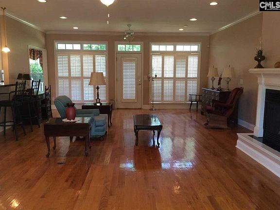 Large open living room with gleaming hardwoods and recessed lighting.