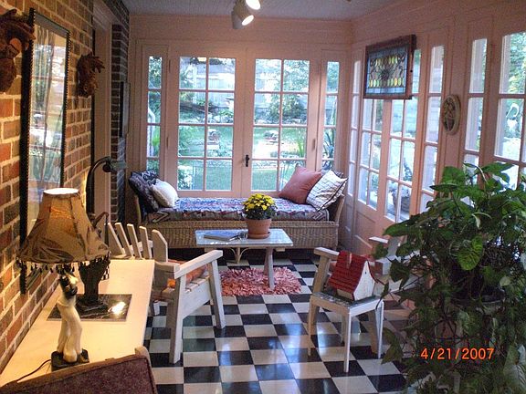 Sunroom with Original Stone Tile Floor and 3 Sets of French Doors