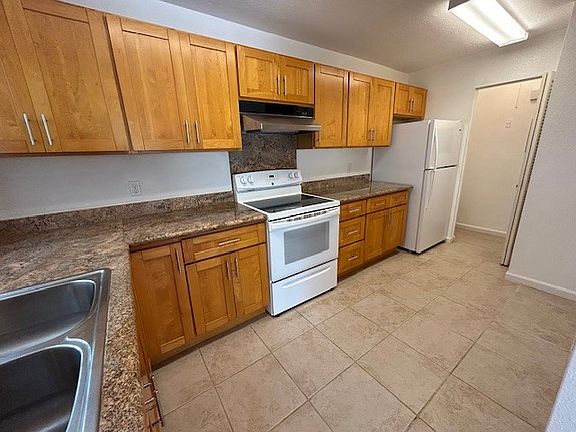 Second view of kitchen with enclosed pantry