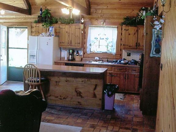 kitchen has island breakfast bar, dishwasher, smooth cook top, wall oven.