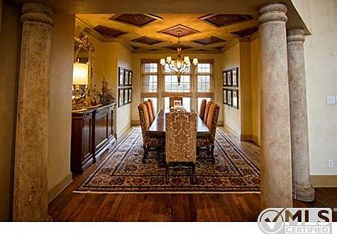 Large formal dinning with stone columns and bright wall of windo