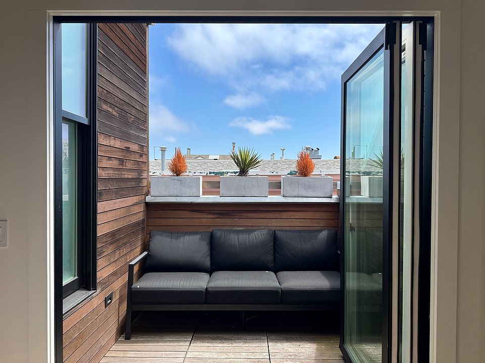 Private, wind-protected deck; accordion door open.