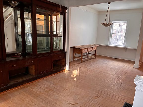 Looking towards the living room and dining room from the back side of the room. Giant. Giant built-in cabinet for records and valuables.