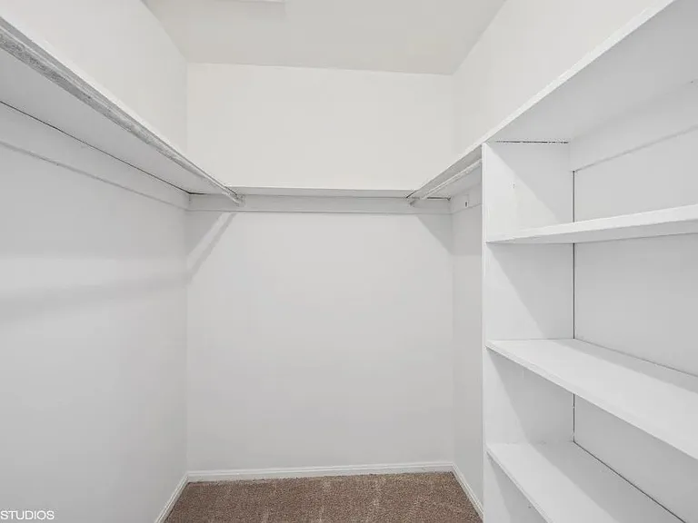 Large walk in closet with tons of storage