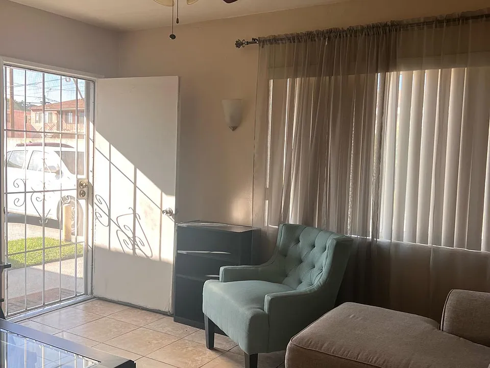 Living room with ceiling fan and tile floor (furniture not included)