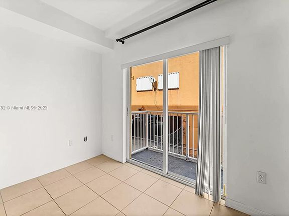 Living Room: Features new blinds replaced 6 months ago, with a curtain rod included in the rent.