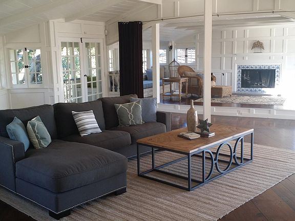 Second Floor multifunctional Big Room with adjacent lounge/work area and two built-in couch/guest beds and fireplace; has East and West double doorways, former leading to 400sf tiled balcony with 180+ degree view of Silicon Valley/ East Bay Hills and latt