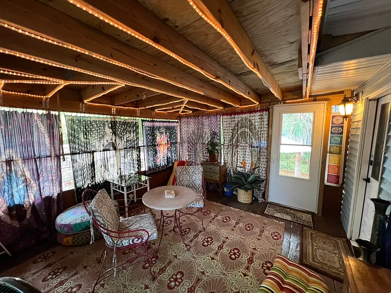 Huge, screened-in, private patio with rope lighting and tapestry curtains. Lovely table and chairs. Carpeted. Boho cushions for extra seating. Boho dressers (2) for extra storage.