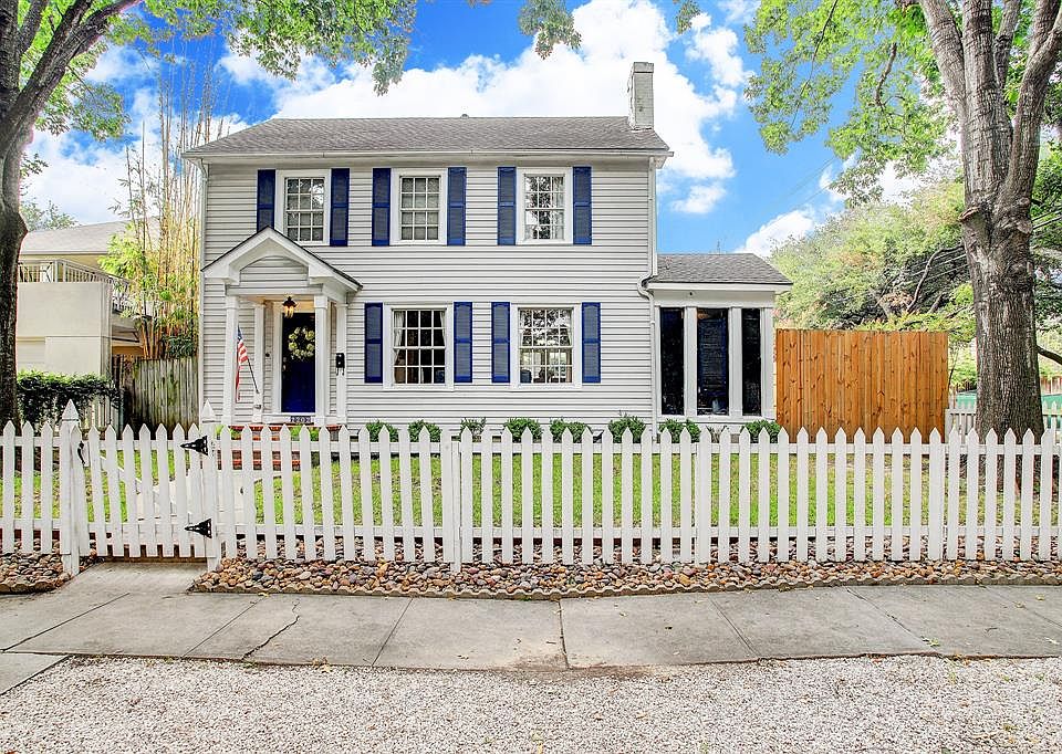 Mature trees and a white picket fence welcome you to this adorable home in Boulevard Oaks!