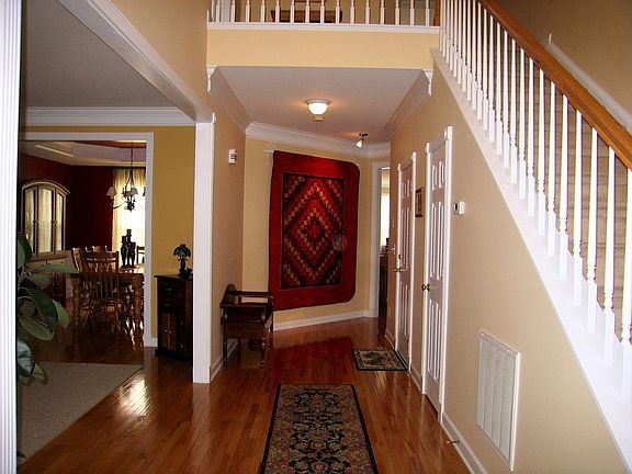 Elegant Foyer with gleaming hardwood floors