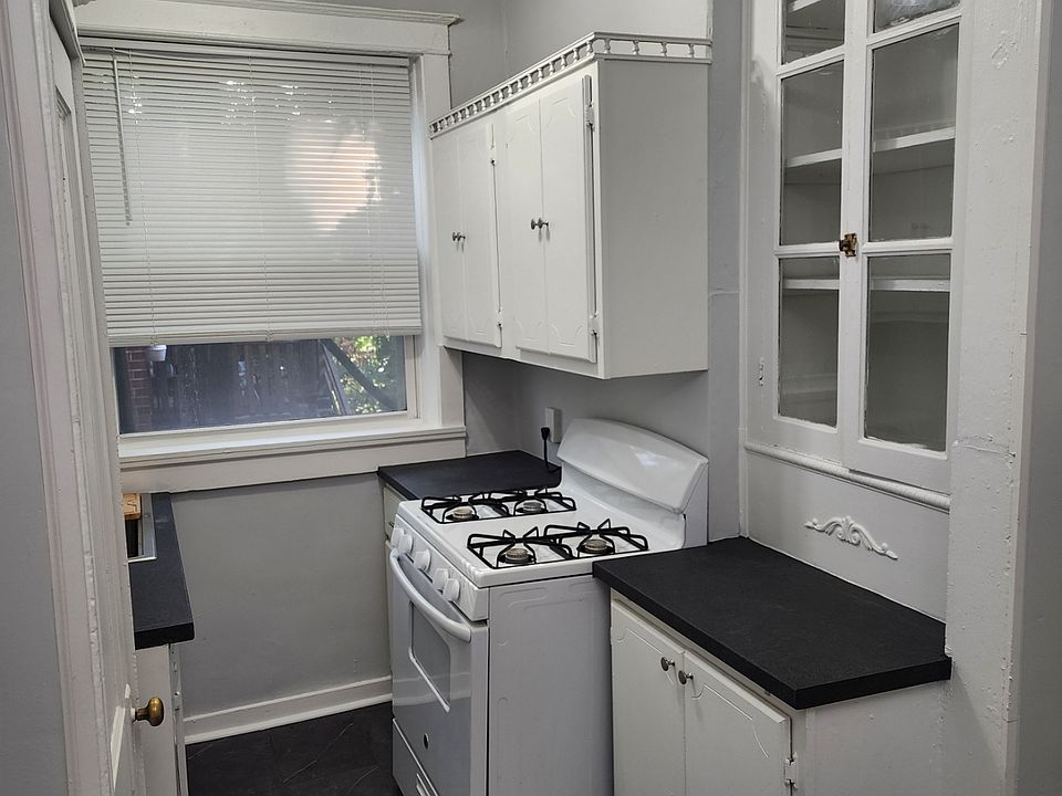 One side of the kitchen with new floors, counter tops, ceiling fixtures and sink. Dishwasher and Gas Stove