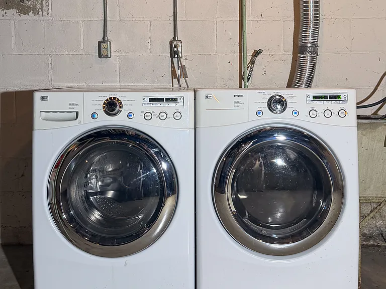 Front load washer and dryer in a clean basement