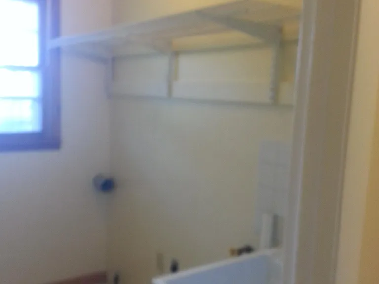 Laundry area with sink. Tile floor.